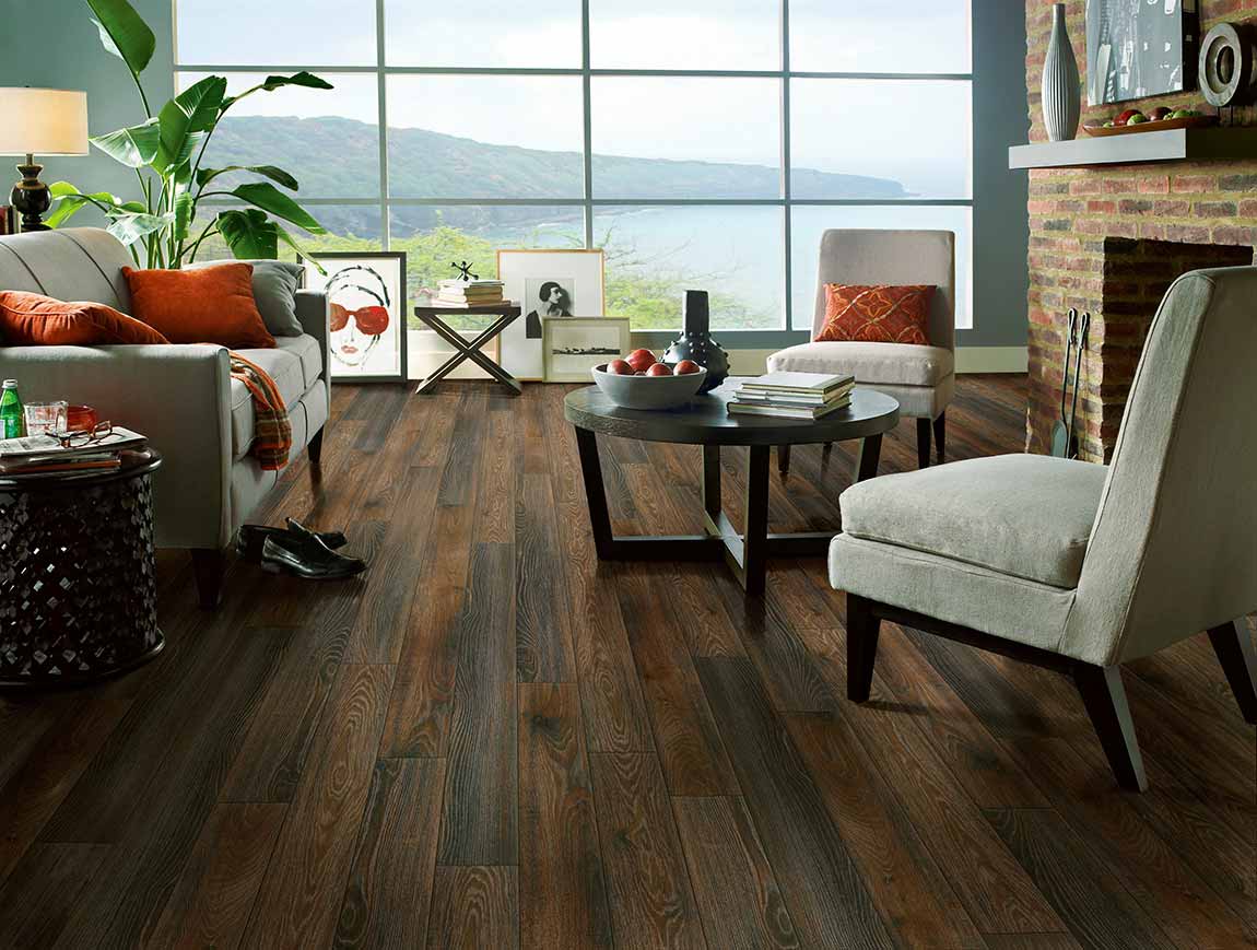 Laminate Flooring via My Design Finder. Wood-look laminate in living room overlooking lake setting surrounded by pine trees.